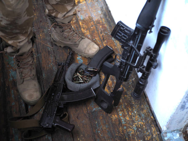istock soldier boots and handgun close up. war 1024029798
