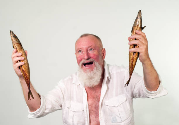 istock Euphoric fisherman with two fishes in his hands 1024036366
