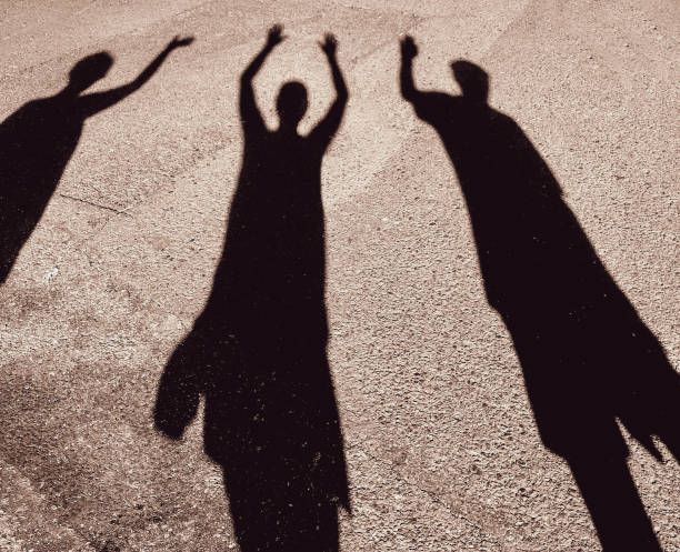 istock shadow of three people waving 1024039736