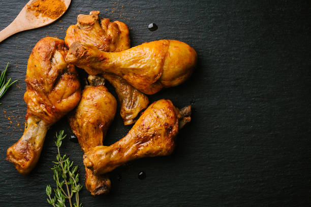 istock Roasted barbeque chicken legs on slate 1024040350
