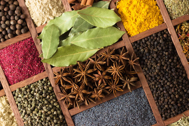 istock Spices and herbs in wooden boxes. Multicolored condiments close-up, as background. 1024052826