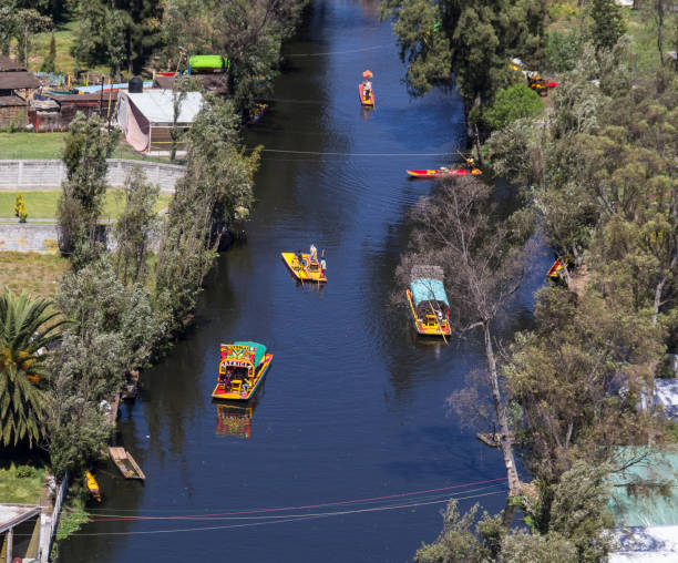 Aerial view of Xochimilco channel and gardens Mexico City, March 16, 2015: boats taking tourists through this UNESCO world heritage site trajinera stock pictures, royalty-free photos & images