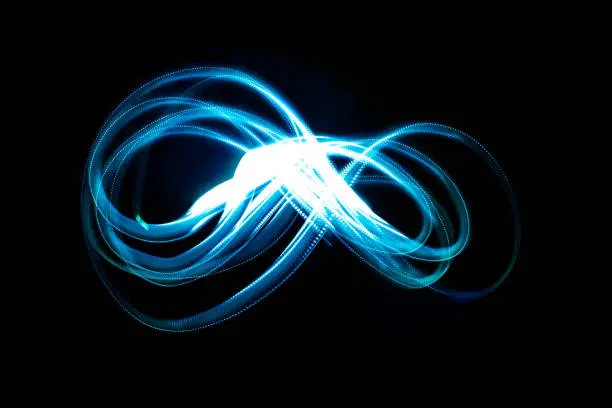 An abstract long exposure of the infinity symbol loop at night.