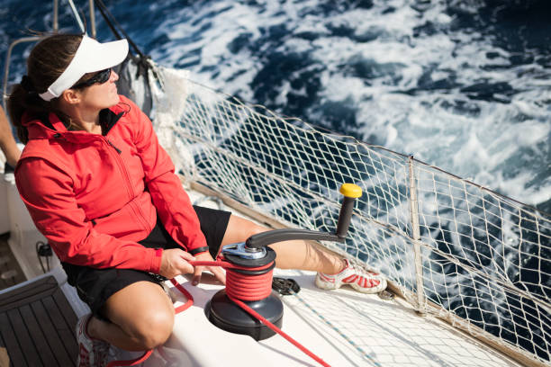 istock Attractive strong woman sailing with her boat 1024069514