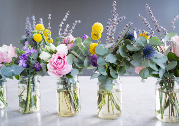 istock Flowers in jar, beautiful bouquet on table on gray background 1024069678