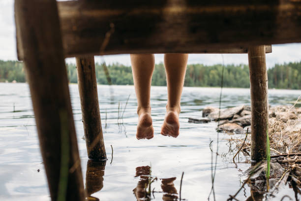 istock Woman sitting on a jetty 1024069902