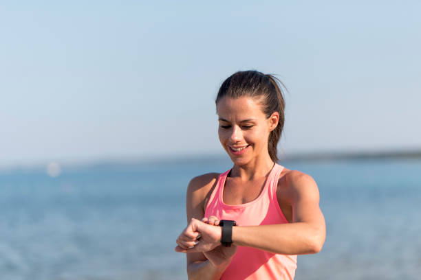 istock Female athlete looking at her wrist watch 1024070006