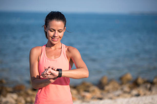 istock Female athlete looking at her wrist watch 1024070012