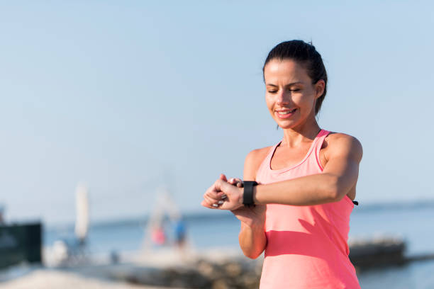 istock Female athlete looking at her wrist watch 1024070032
