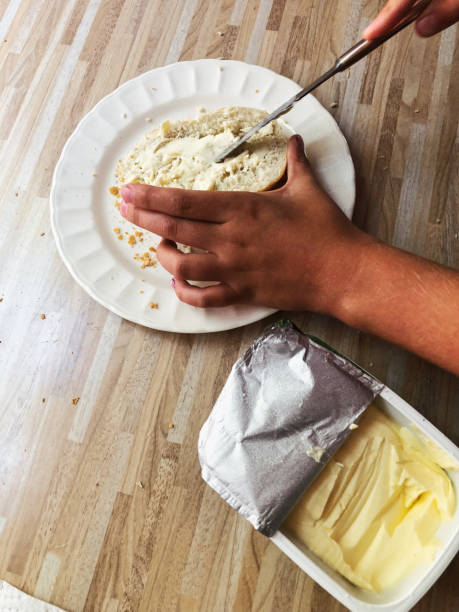 istock Child making a sandwich on wooden table 1024070454