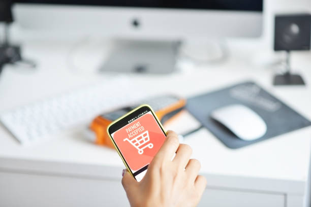istock Businesswoman paying with smartphone using an mobile POS terminal 1024070548