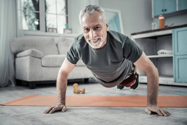 istock Positive delighted senior sportsman doing push-ups 1024070562
