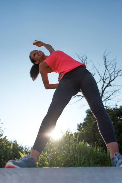 istock Young woman stretching outdoors 1024070594