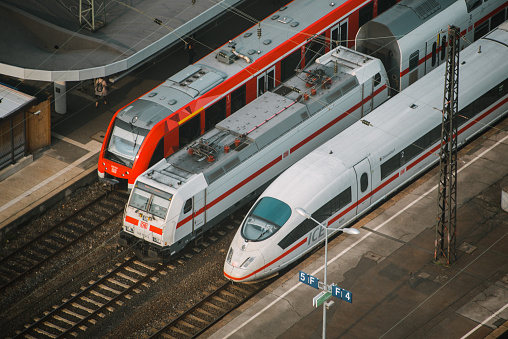 three different German trains, one of them ICE (high speed), in a station in Cologne