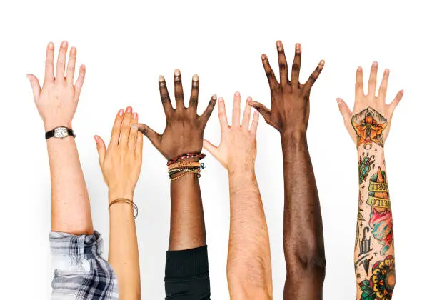 Photo of Diversity hands raised up gesture
