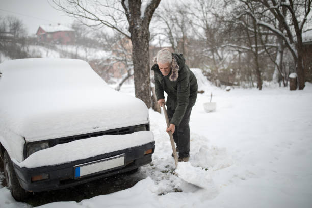 istock Stuck in snow. Senior man with shovel removing snow 1024077928