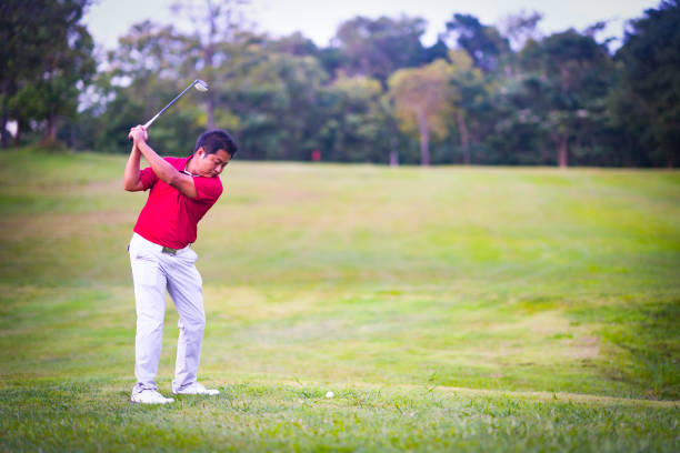 istock Golf sport concept, golfer swing golf ball on golf course on beautiful fairway and layout. Player stand hitting ball on grass on daytime 1024078358