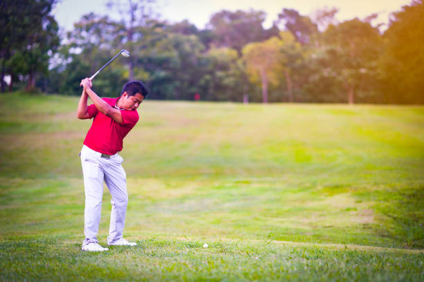 istock Golf sport concept, golfer swing golf ball on golf course on beautiful fairway and layout. Player stand hitting ball on grass on daytime 1024078384