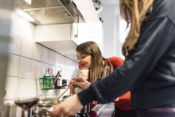 istock young woman cooking together in kitchen 1024078406