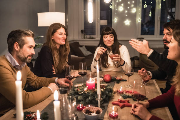 istock young happy people talking at christmas table 1024079028