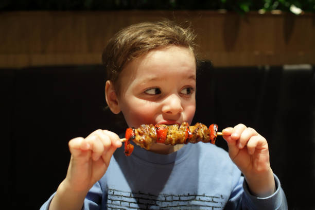 Child eating a kebab stock photo