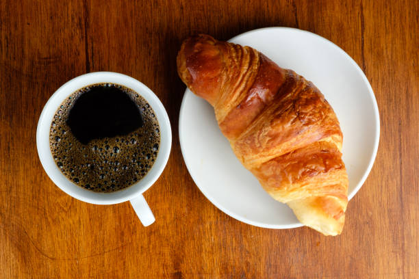 istock Top view of black coffee and croissant bread for breakfast 1024088428