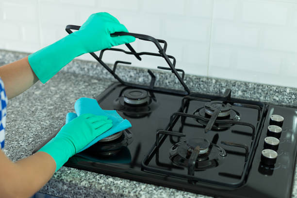 istock Woman cleaning stove 1024091262