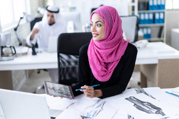 istock Smiling arab fashion designer working 1024096674