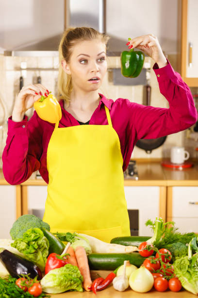 istock Woman holding bell peppers paprika thinking 1024105964