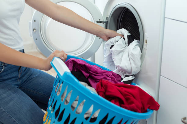 istock Woman with a laundry basket washing clothes 1024106056