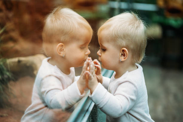 istock Pensive little girl with reflection on glass 1024106112