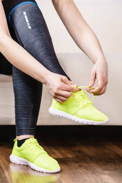 istock Woman putting sport shoes 1024106928