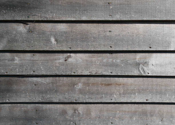 istock Weathered gray raw wood boards background wallpaper 1024106992