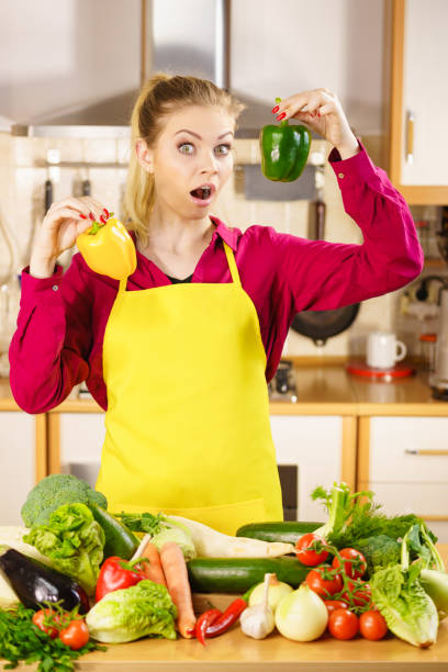 istock Woman holding bell peppers paprika thinking 1024107098