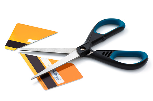 Scissors and cut credit card on white background