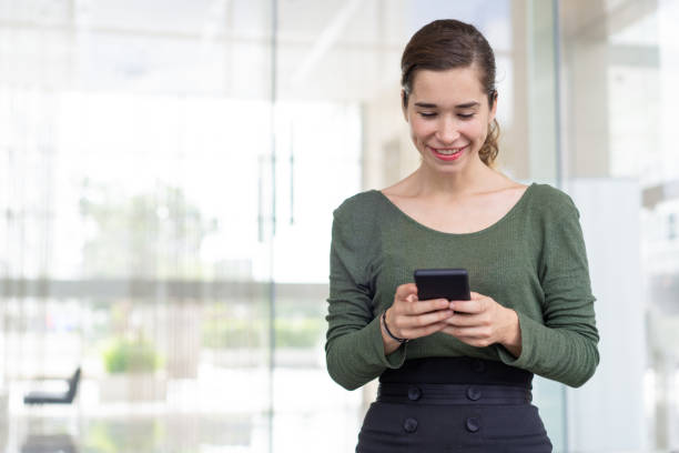 istock Happy office employee texting message outdoors 1024116048