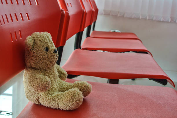 istock Teddy Bear On red chair 1024117238