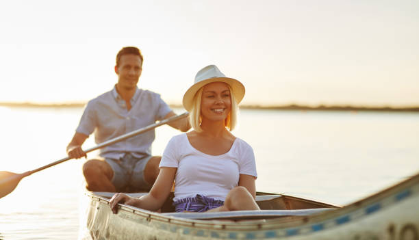 istock Smiling young couple enjoying a sunny day canoeing together 1024117256