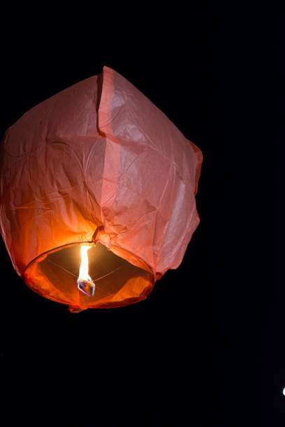 istock Chinese Flying Lantern Flying on Dark Background 1024123618
