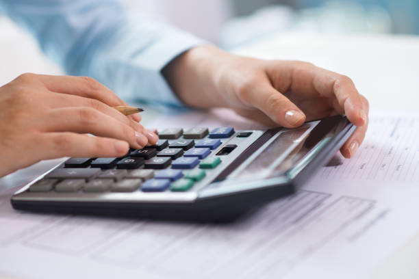 istock Closeup of economist working and counting data on calculator 1024124206