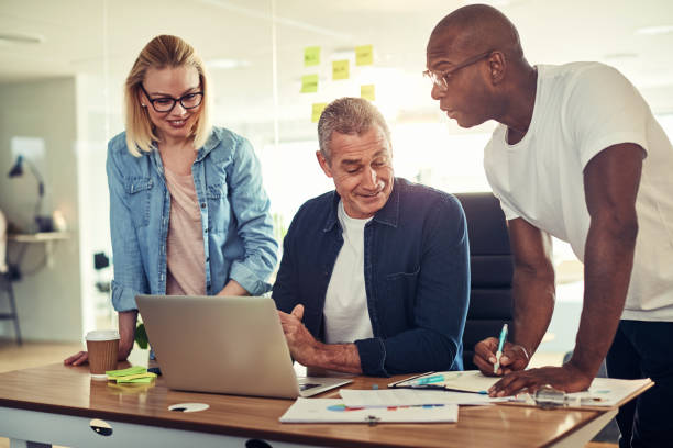 istock Smiling diverse businesspeople using a laptop together in an office 1024129042