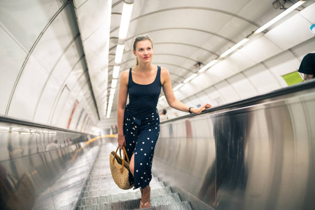istock Beautiful woman on a escalator 1024129512