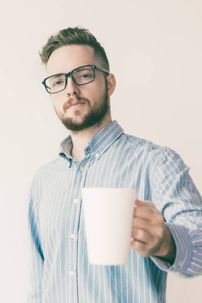 istock Serious Young Man with White Cup and Toast Gesture 1024130258