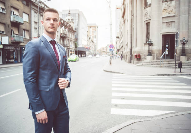 Stylish businessman standing on the city street