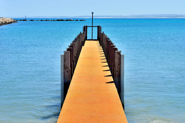 Boardwalk at bay of water in sunny day, Geraldton, Western Australia.