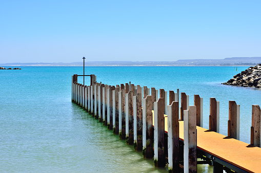 Boardwalk at bay of water in sunny day, Geraldton, Western Australia.