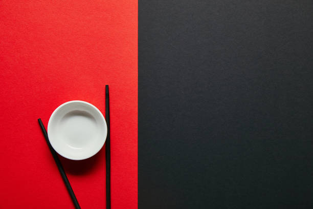 istock top view of arranged empty bowl and chopsticks on red and black background 1024131636