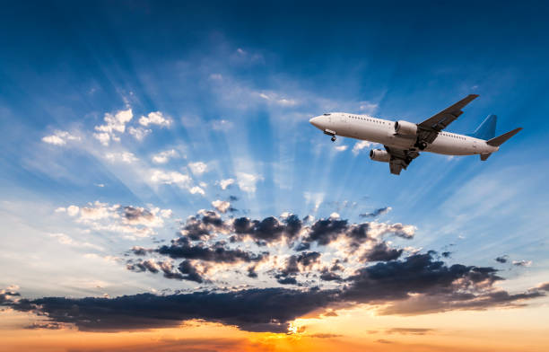 istock Airplane in the sky and cloud at sunrise 1024136324