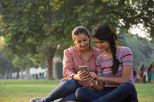 istock friends watching videos on a smartphone - Stock image 1024139200