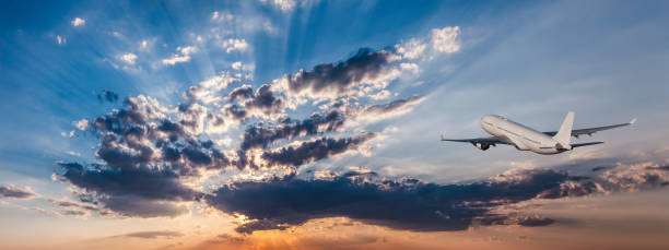 istock Airplane in the sky and cloud at sunrise 1024139406
